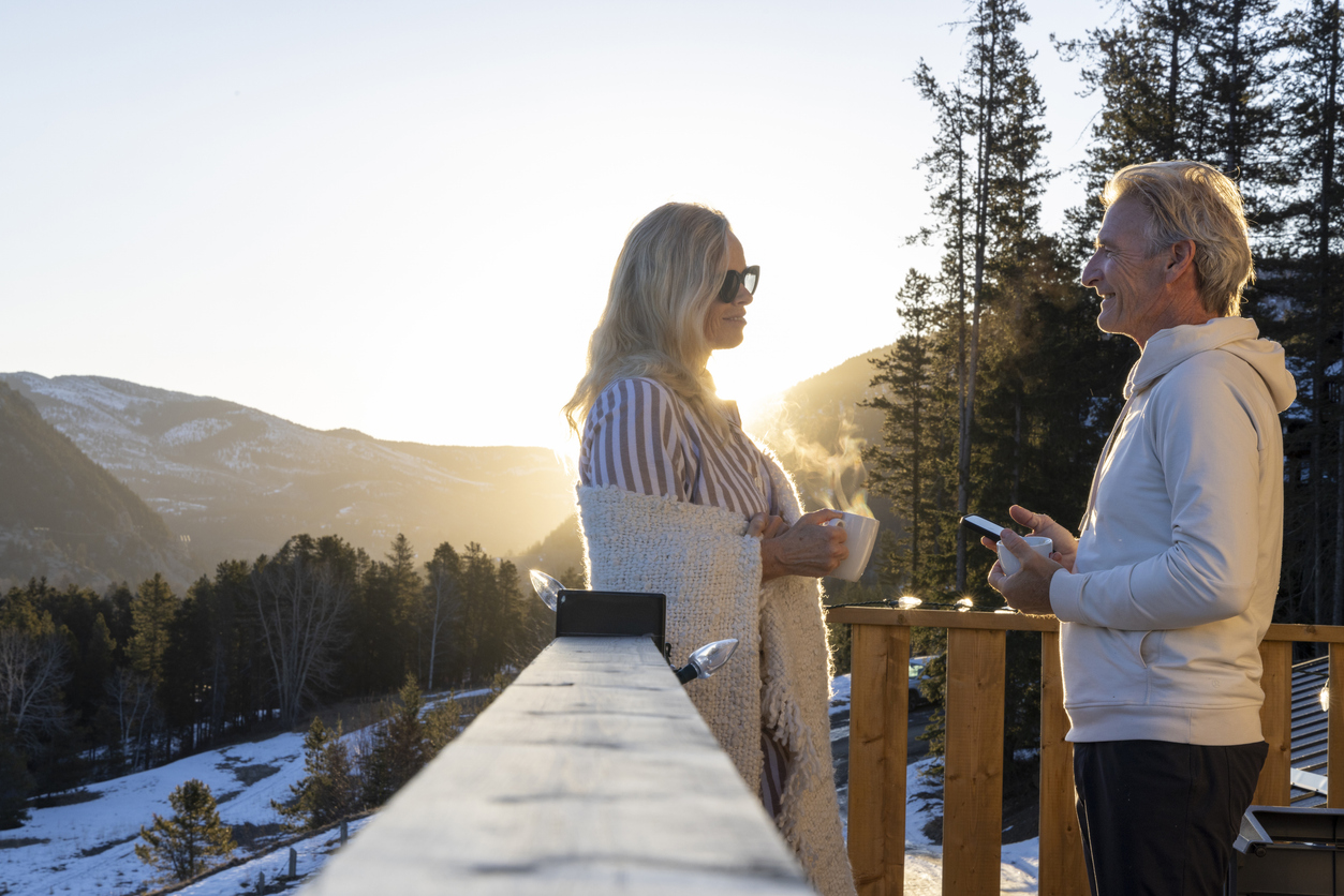 Couple outdoors in Canada with coffee at sunrise, representing US expats considering RRSP withdrawals and US tax treatment.