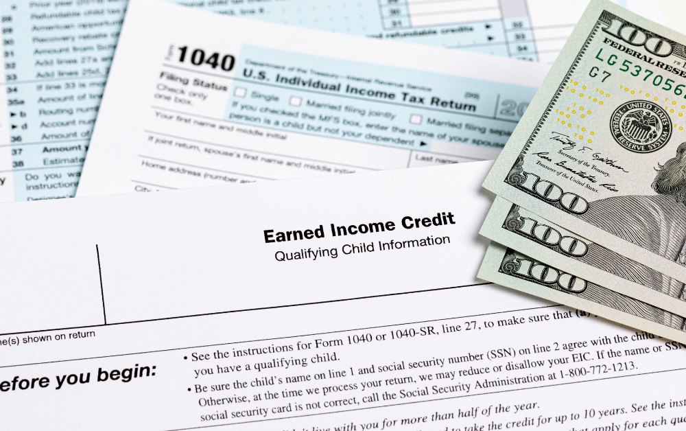 Form 1040 with Earned Income Credit qualifying child information section and hundred dollar bills, representing EITC tax refunds for eligible American expats