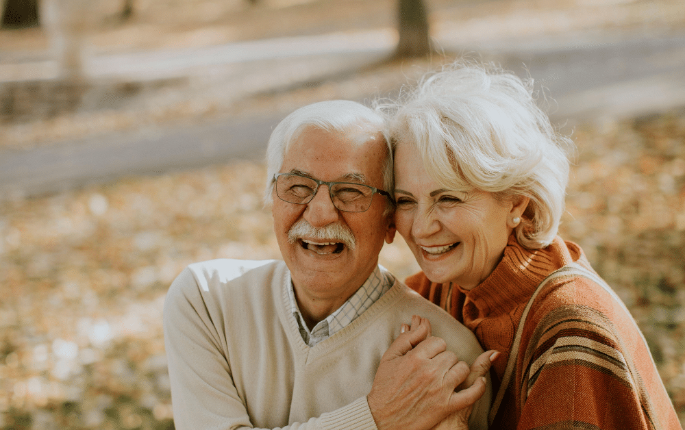 Happy retired couple enjoying retirement in Germany after successfully managing their German pension and US tax obligations